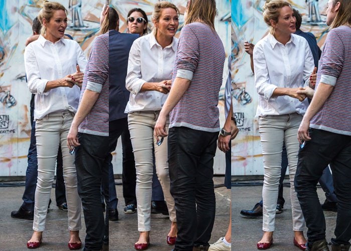 Uma Thurman smiles on the set of her new project "The Brits are Coming" in an all-neutral outfit paired with red flats