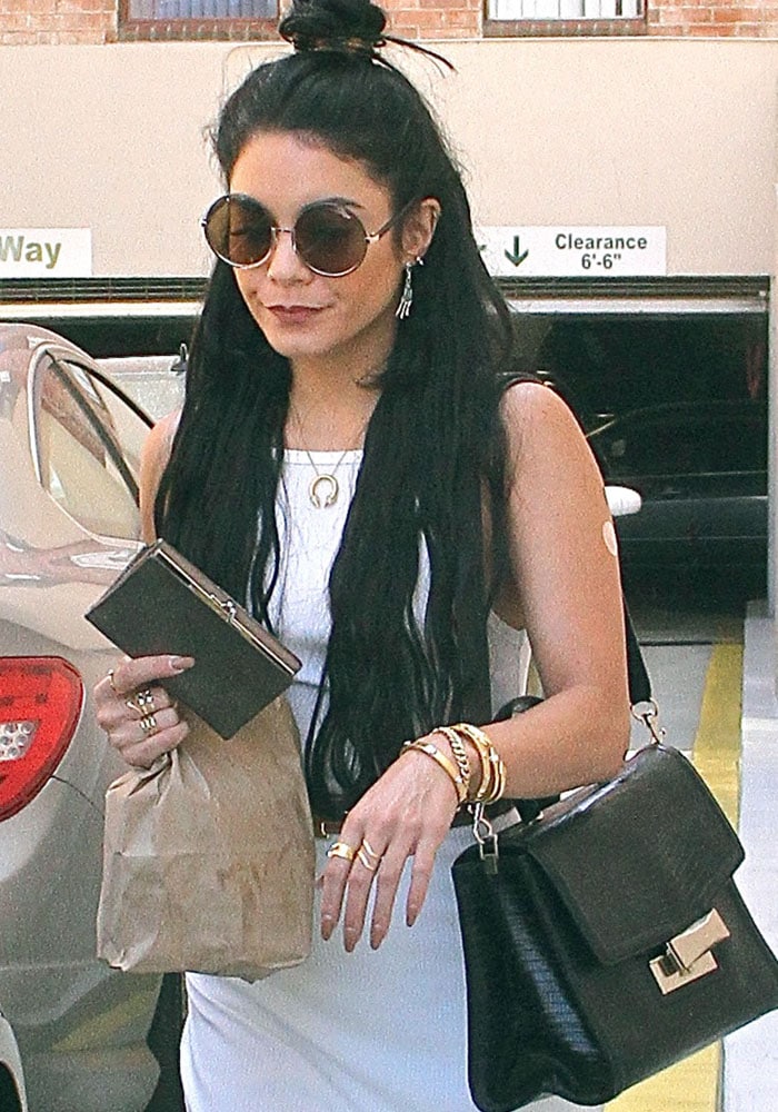 Vanessa Hudgens leaves a Los Angeles clinic with a bandage on her left arm