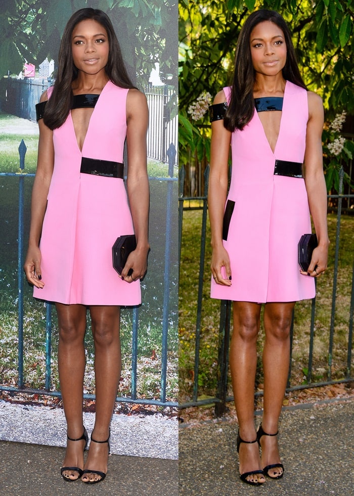 Naomie Harris flaunts her legs in a bold pink Christopher Kane shift dress, perfectly paired with black Giuseppe Zanotti ankle-strap sandals for a sleek finish