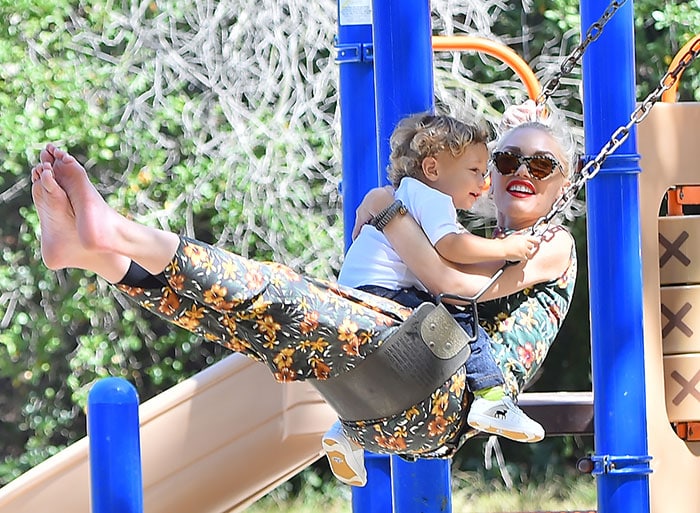 Gwen Stefani ditches her shoes as she spends time swinging with her son Apollo at a Los Angeles park