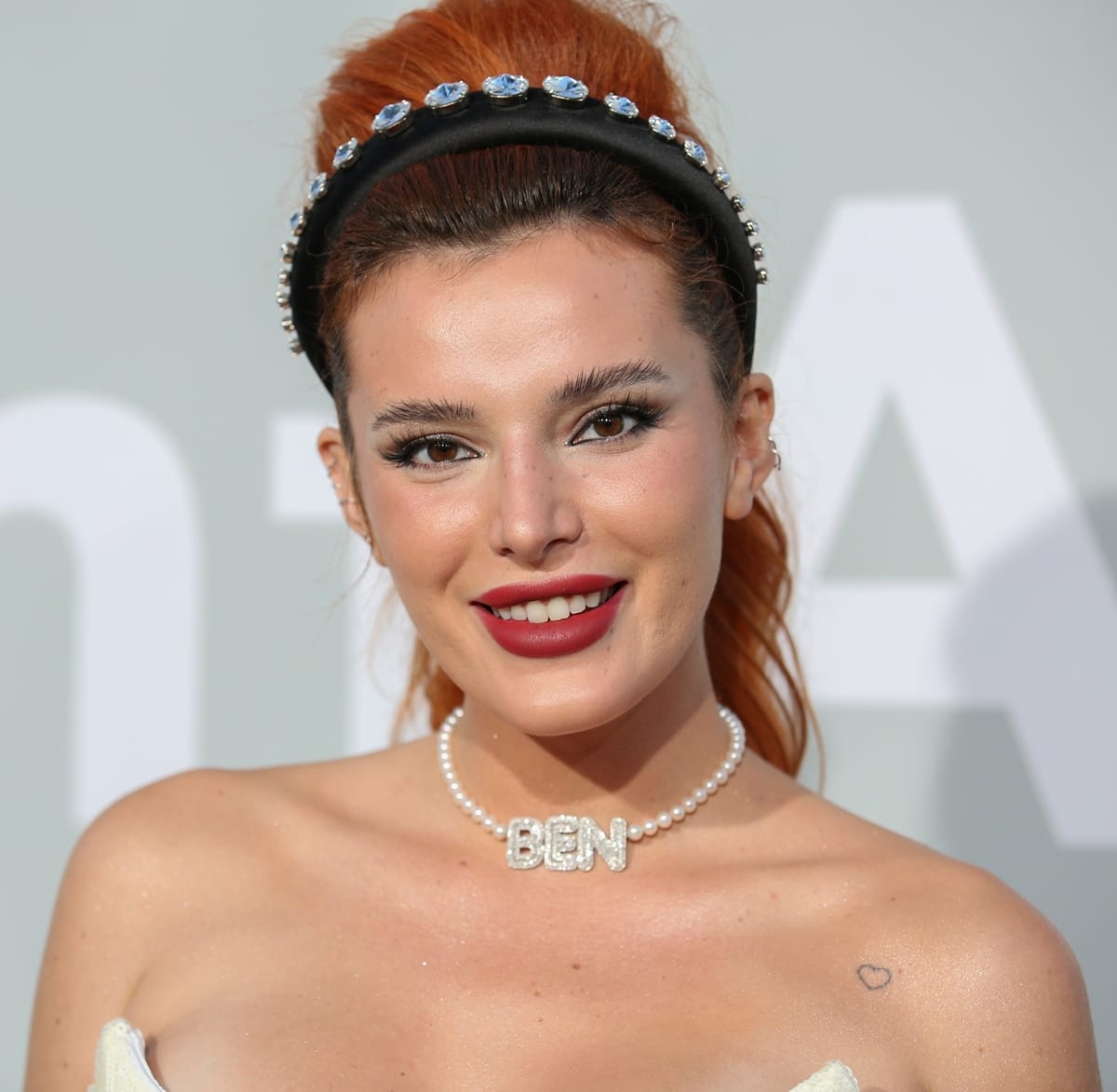 Bella Thorne's crystal-studded headband and pearl necklace with crystal ‘Ben’ lettering