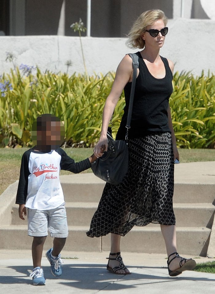 Charlize Theron goes for a stroll with her adopted son Jackson after reportedly adopting a baby girl