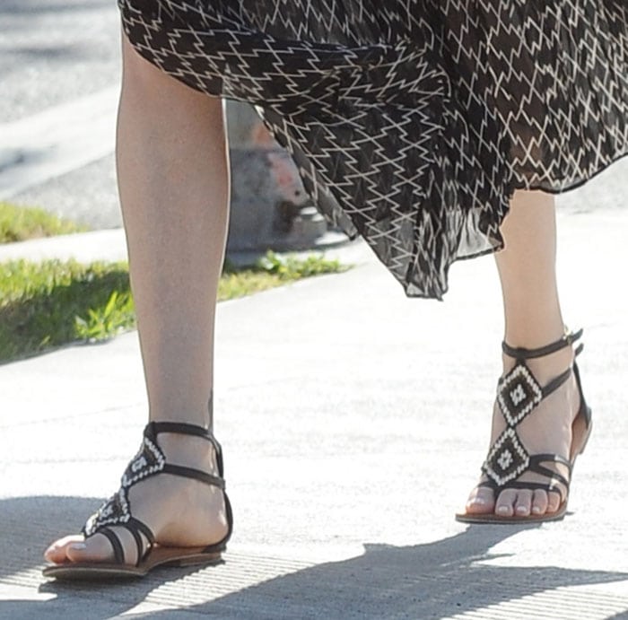 Charlize Theron wears Cocobelle sandals during a walk