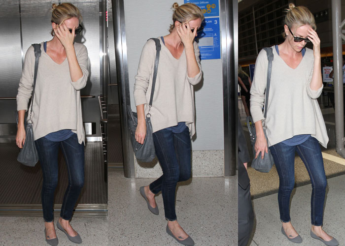 Charlize Theron completed her airport fashion with sunglasses, a gray tote, and gray suede ballerina flats