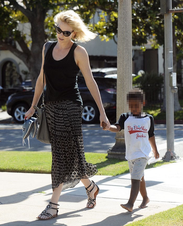 Charlize Theron's blonde bob blows in the wind as she takes a stroll with her barefoot son, Jackson