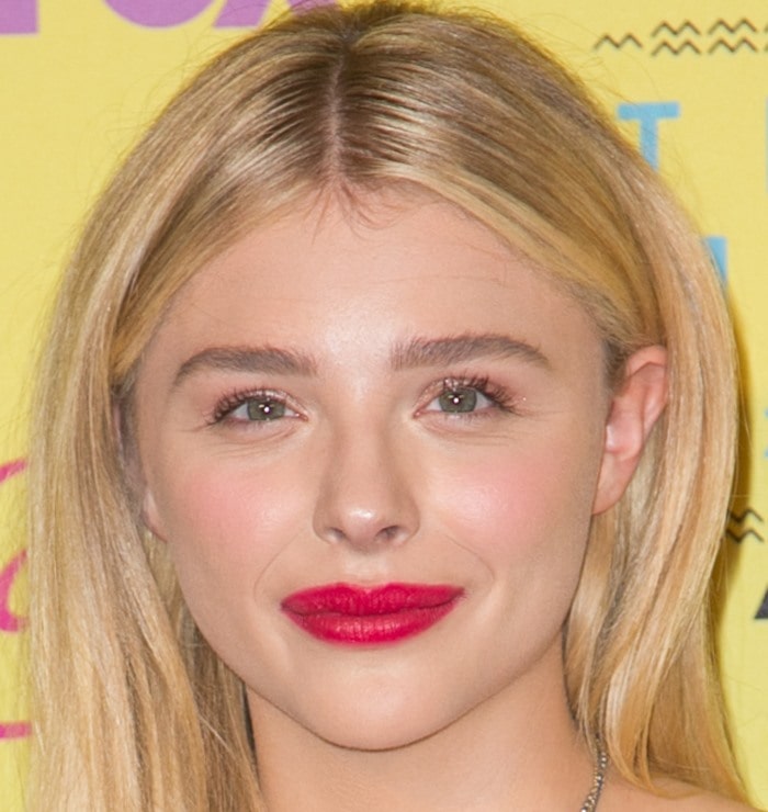Chloë Grace Moretz showcased a sleek and simple hairstyle with straight, center-parted blonde locks