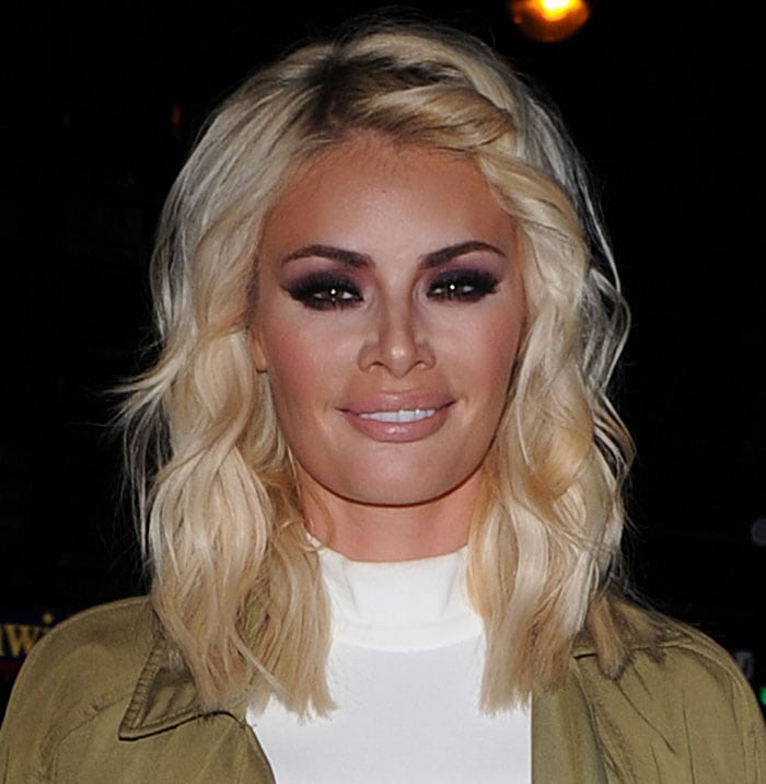 Chloe Sims with heavy smoky eye makeup and curled blonde hair