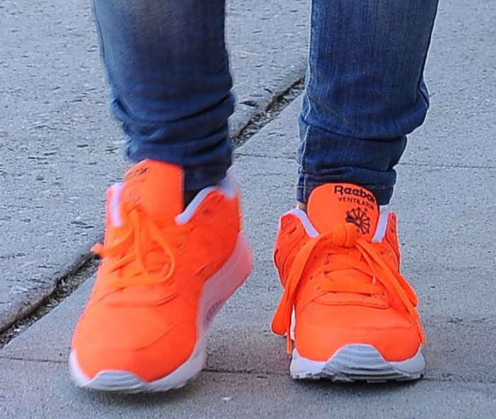 Christina Milian trades her towering heels for a comfortable and bright pair of Reebok sneakers