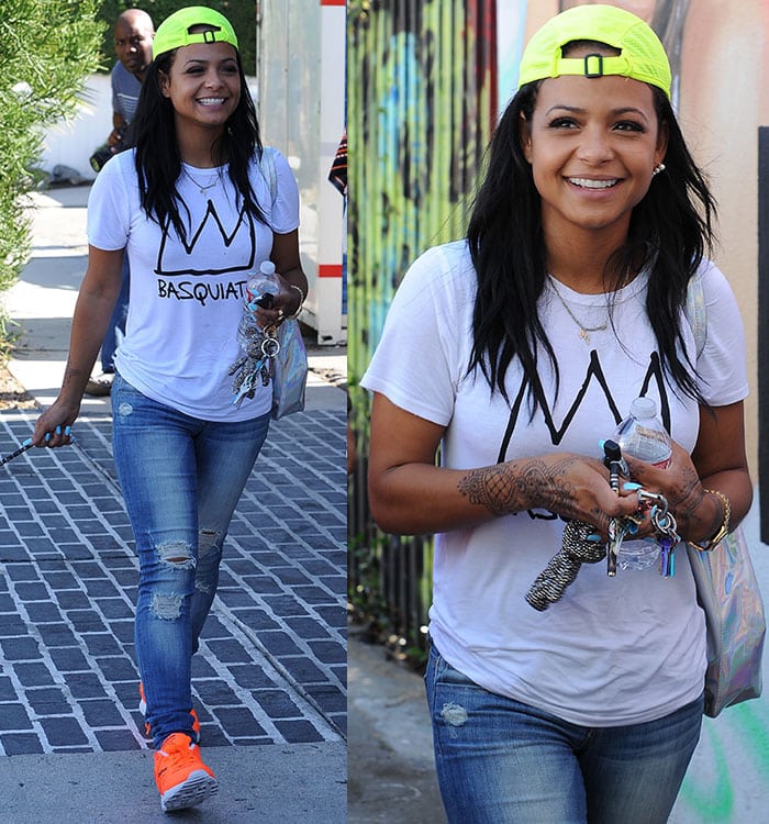 Christina Milian shows off a neon baseball hat perched atop her long dark hair during a walk