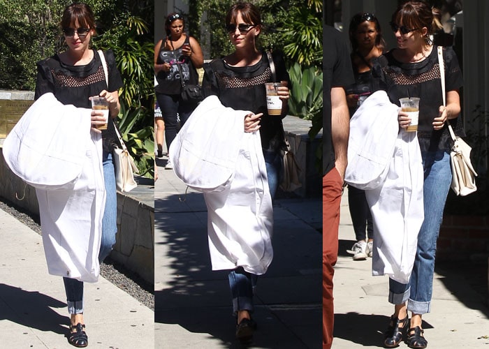 Dakota Johnson grabs her laundry and a cold coffee