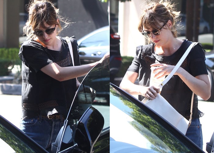 Dakota Johnson in a perforated black top and boyfriend jeans