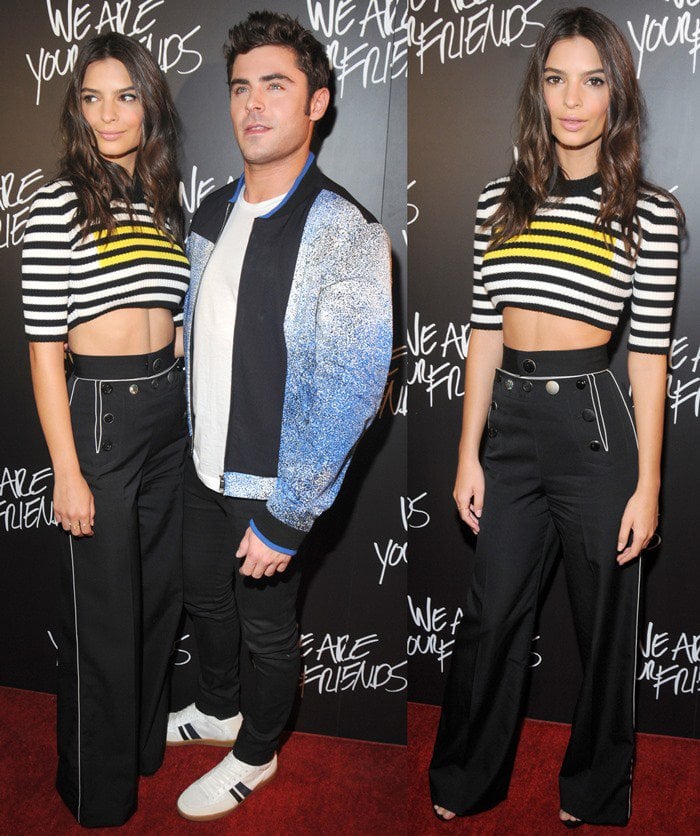Emily Ratajkowski stuns in a striped cropped top and high-waisted black pants while posing with Zac Efron at the We Are Your Friends premiere