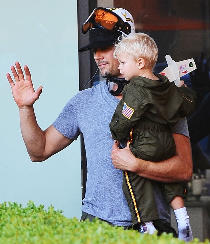 Fergie's husband, Josh Duhamel, hoists Axl on his hip and waves