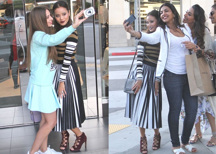 Jamie Chung poses for selfies with fans outside a Sephora storefront