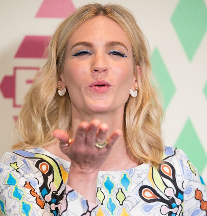 January Jones blows a kiss in a psychedelic print minidress