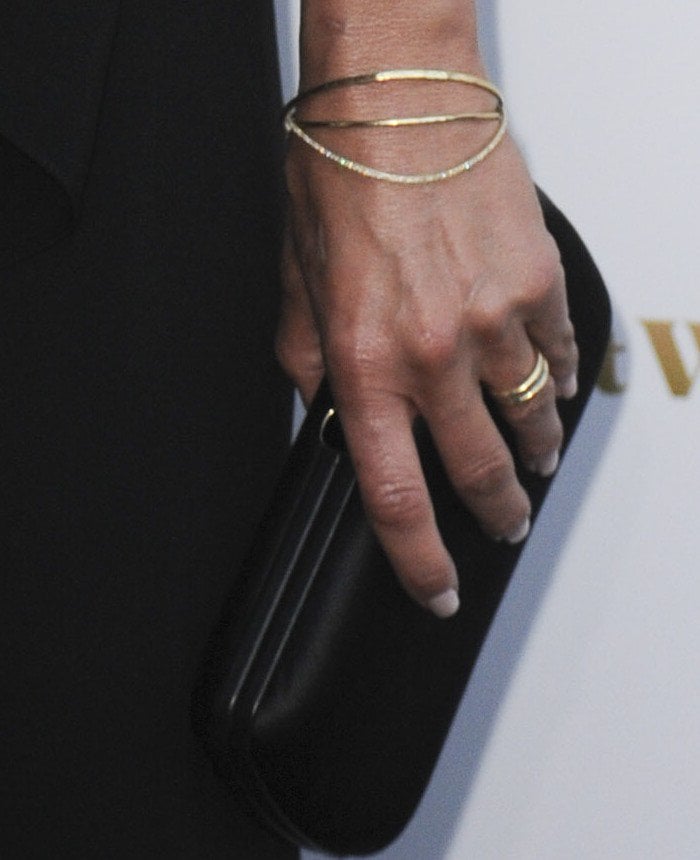 Jennifer Aniston wearing a new gold and diamond wedding band on her left finger at the premiere of "She's Funny That Way"