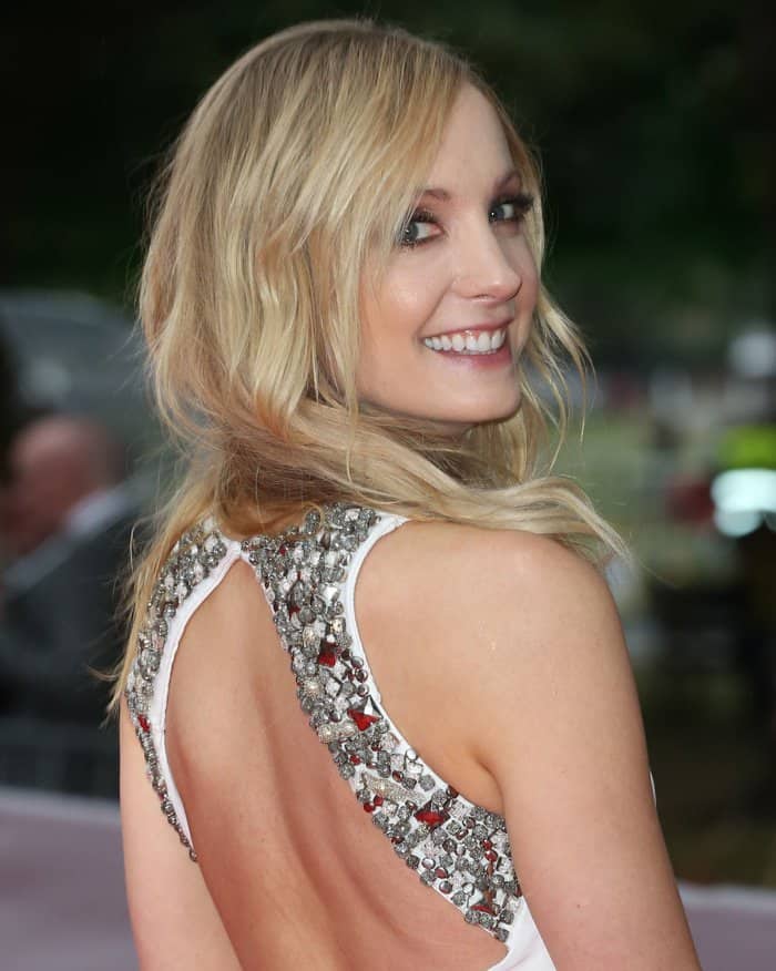 Joanne Froggatt radiates with soft, tousled waves and a sparkling embellished gown, showcasing a flawless red carpet look