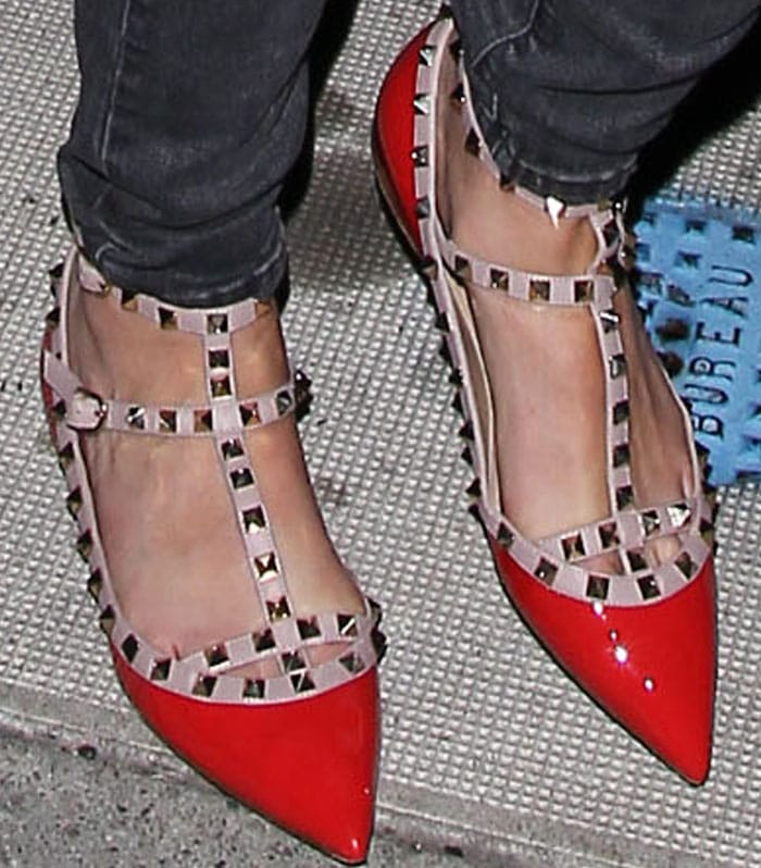 Katherine Heigl steps out in bold red Valentino Rockstud flats, featuring edgy pyramid studs and a T-strap design that adds a chic, statement-making touch to her look