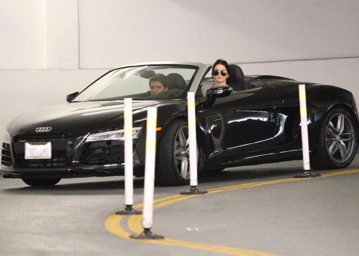 Kendall Jenner behind the wheel of a new 2014 Audi R8 V10 Spyder on her way to Go Greek to fetch frozen yogurt with a male friend