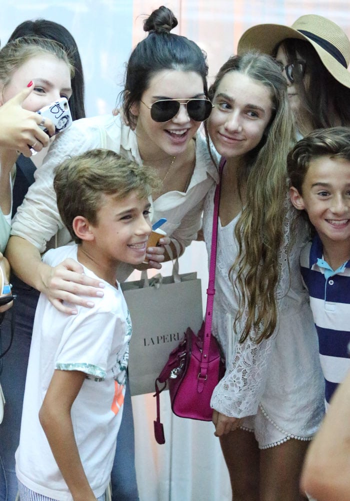 Kendall Jenner takes a photo with fans