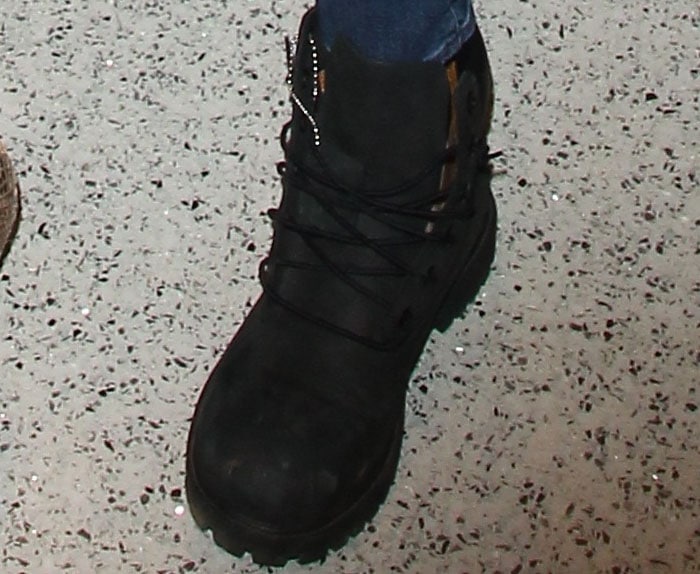 Khloé Kardashian shows off a comfy pair of black Timberland boots for her airport stroll