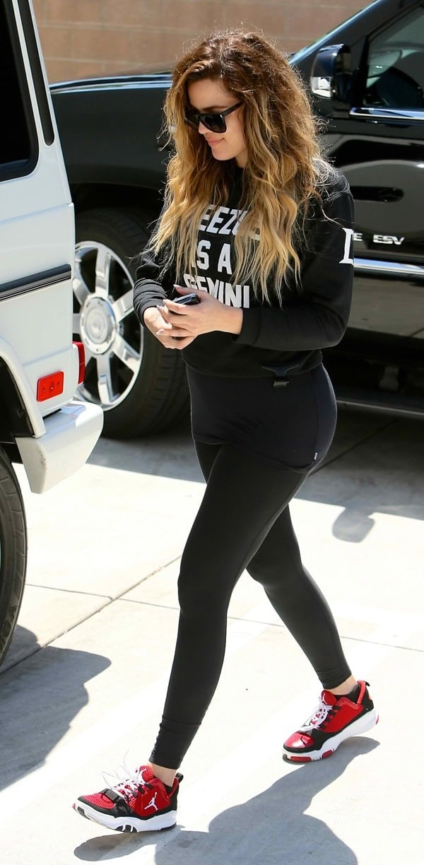 Khloé Kardashian getting out of a limousine, wearing a 'Yeezus is a Gemini' top, after a shopping trip with her mother, Kris Jenner, in California on April 24, 2014