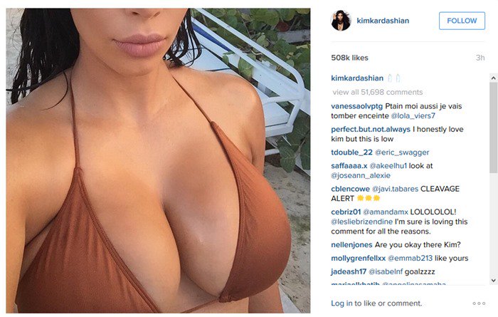 Kim Kardashian shows off her pregnancy curves in a gold-colored bikini