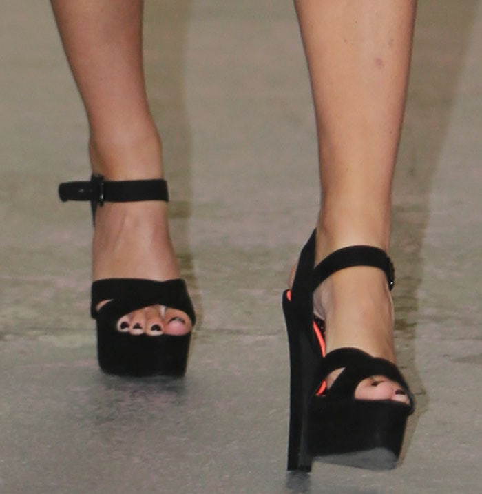 Sarah Harding's black pedicure shows from beneath the peep toes of her black platform sandals