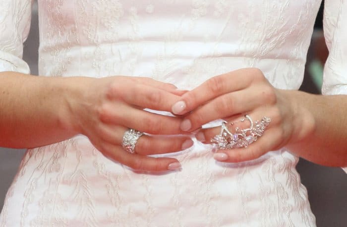 Lily James wears a large diamond cluster ring and a delicate, multi-stone ring with intricate detailing