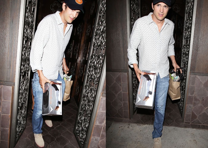 Ashton Kutcher carrying the HyperIce Vyper vibrating fitness roller that he purchased for his wife Mila Kunis