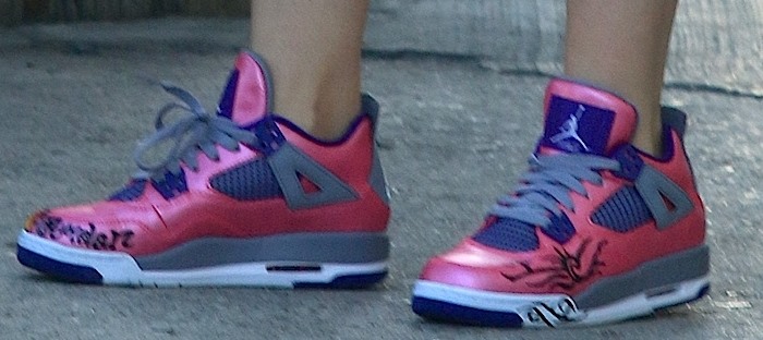 Miley Cyrus shows off the detail on her pink Nike sneakers