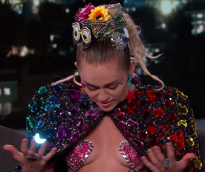Miley Cyrus shows off her heart-shaped nipple pasties while appearing on Jimmy Kimmel Live!