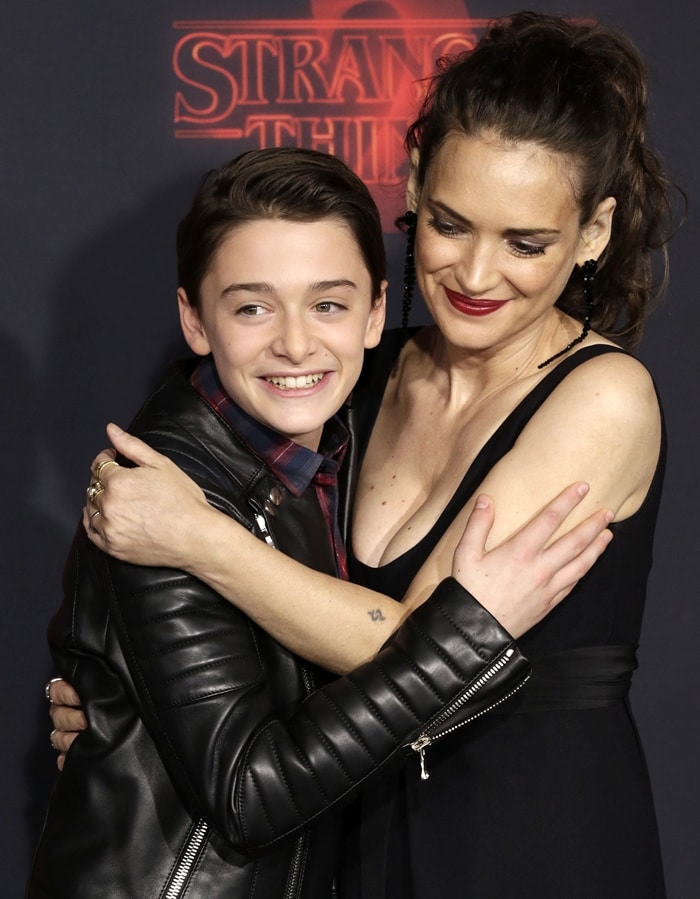 Noah Schnapp hugs his shoplifting co-star Winona Ryder