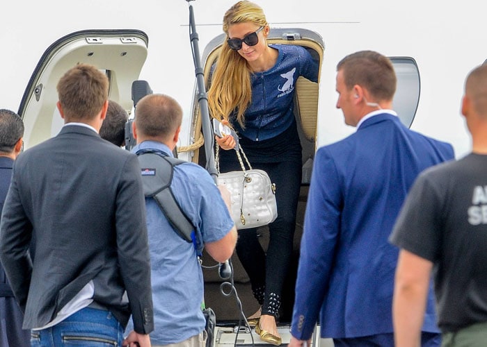 Paris Hilton exits her private jet in a custom ensemble as she arrives in Warsaw