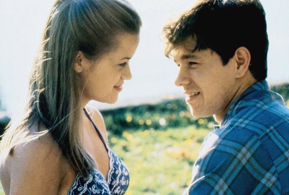 Reese Witherspoon and Mark Wahlberg share a tender moment in Fear (1996), a psychological thriller that showcased Witherspoon’s early acting talent