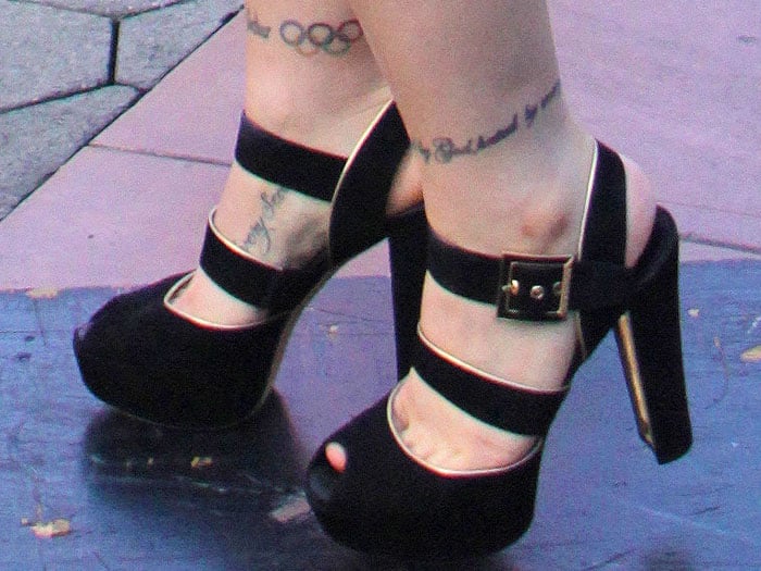 Ronda Rousey's Olympic Rings ankle tattoo and thick-strap black suede peep-toe platform sandals with gold inner heels
