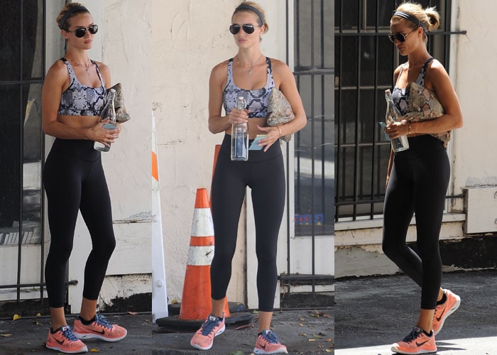 Rosie Huntington-Whiteley juggles her belongings and a bottle of water as she leaves her Los Angeles gym