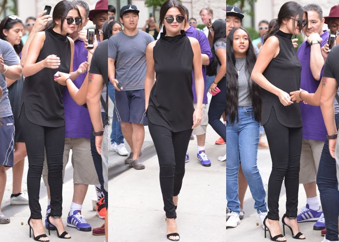 Selena Gomez pauses to chat with fans waiting outside her hotel in New York during a two-day stay