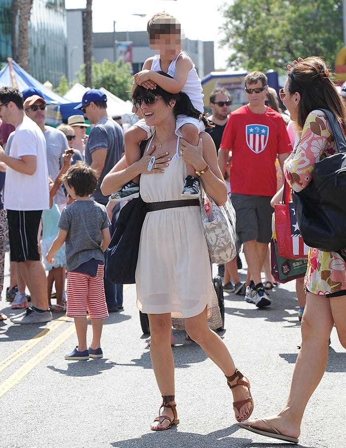 Selma Blair carries two tote bags and her son as she strolls around in the Los Angeles daytime