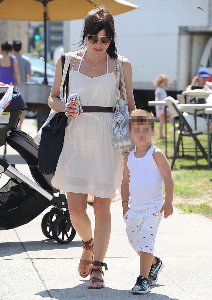 Selma Blair tends to a can of Diet Coke in one hand and her son, Arthur, in the other