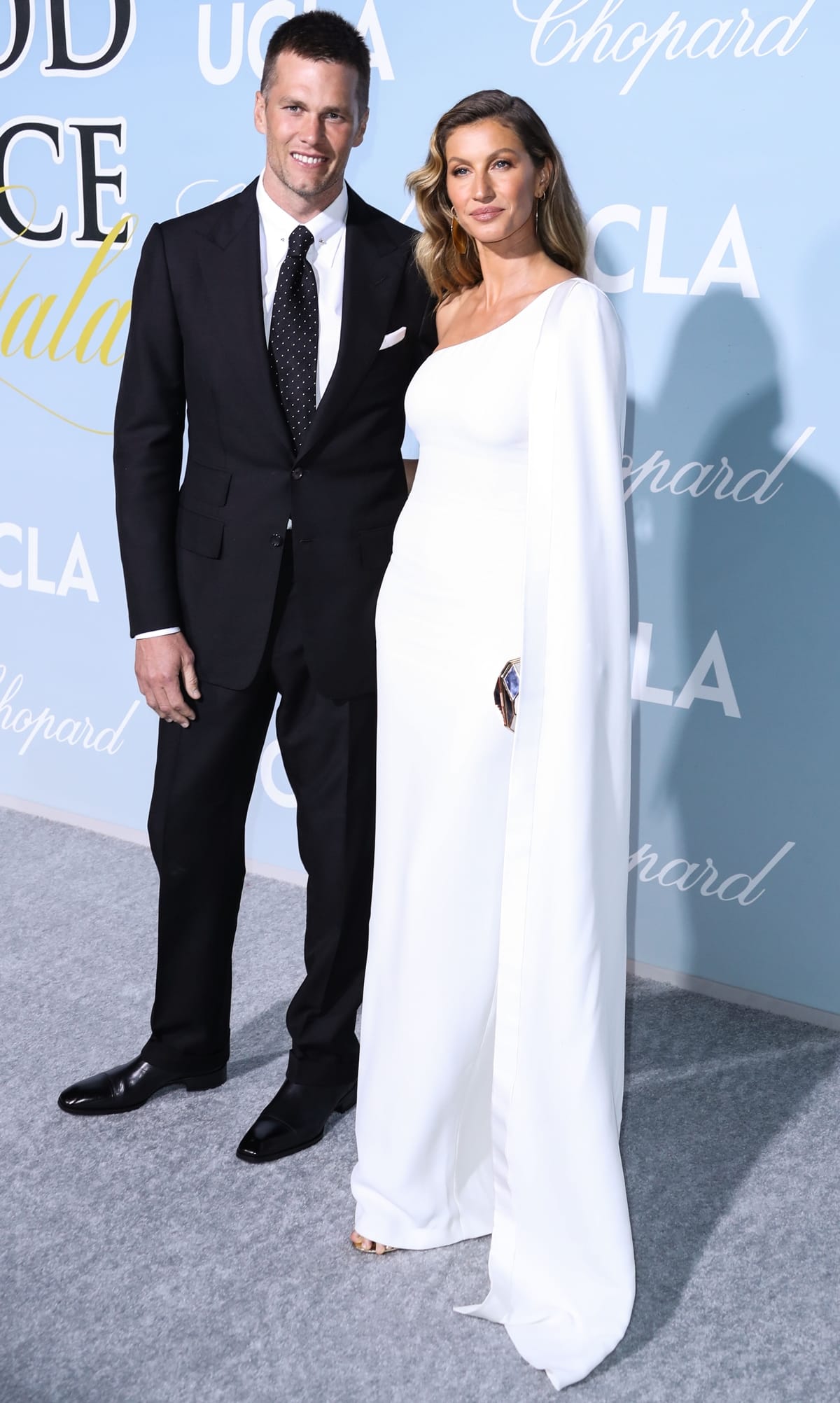 Gisele Bündchen in a white one-shoulder Stella McCartney dress with Tom Brady in a black suit at the 2019 Hollywood For Science Gala