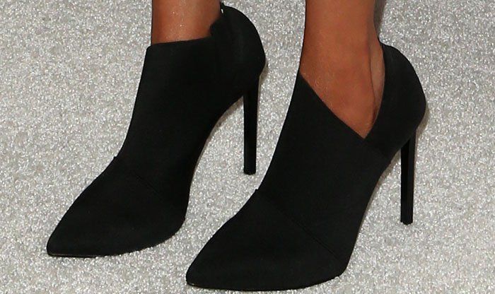 Tyra Banks rocks asymmetrical boots by Tony Bianco