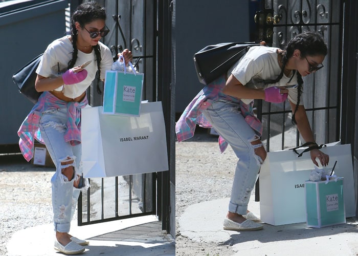 Vanessa Hudgens juggles Isabel Marant and Kate Sommerville shopping bags in a pair of ripped jeans