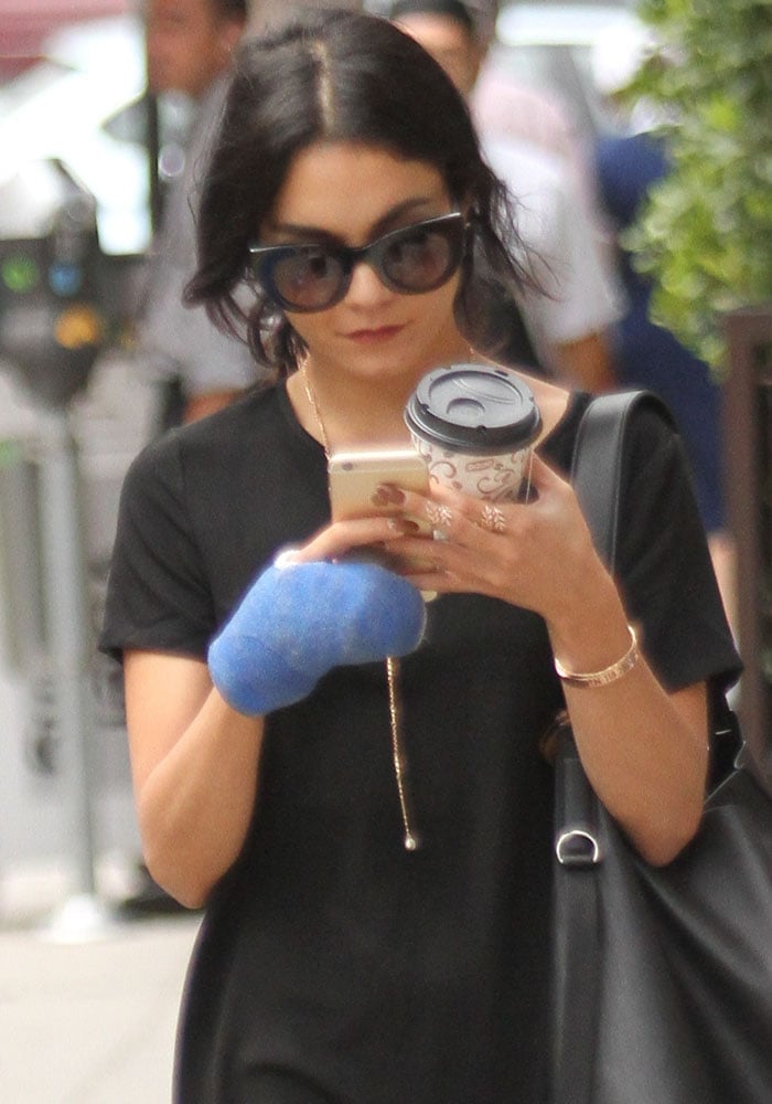 Vanessa Hudgens sports a cast on her right hand as she shops around Los Angeles