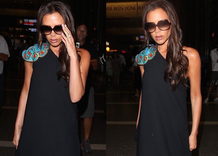 Victoria Beckham covers her eyes with dark shades as she strolls through LAX