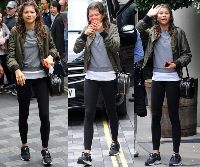 Zendaya clutches her phone, waves and smiles as she leaves her hotel in a casual ensemble