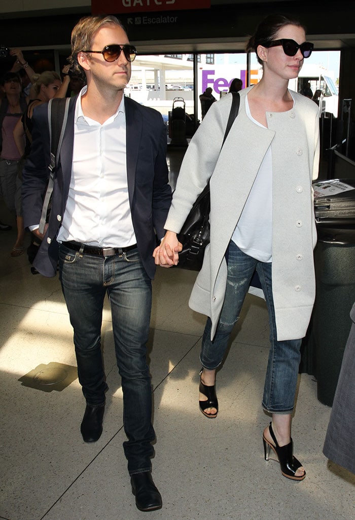 Anne Hathaway and husband Adam Shulman wear matching smart-casual looks at LAX