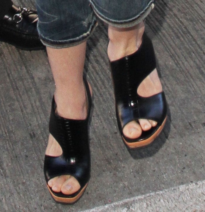 Anne Hathaway wears a pair of Rodarte cutout sandals on her feet