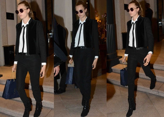 Cara Delevingne in a white collared shirt with a slim tie and black blazer