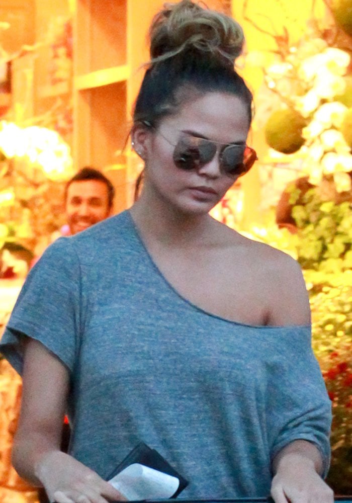 Chrissy Teigen piles her hair onto her head for a Bristol Farms grocery run